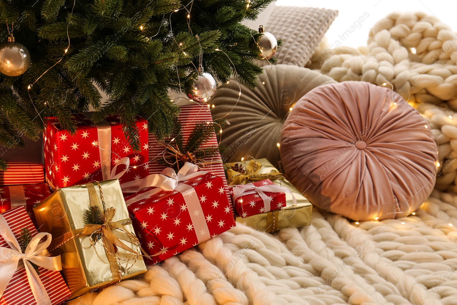 Photo of Beautiful Christmas tree and gift boxes in room