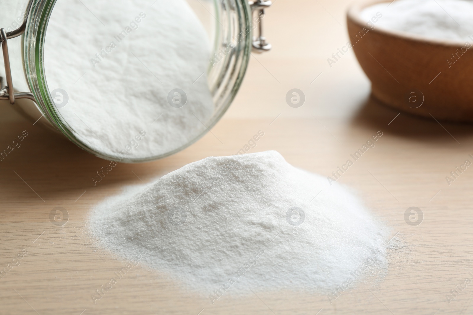 Photo of Pile of baking soda on wooden table