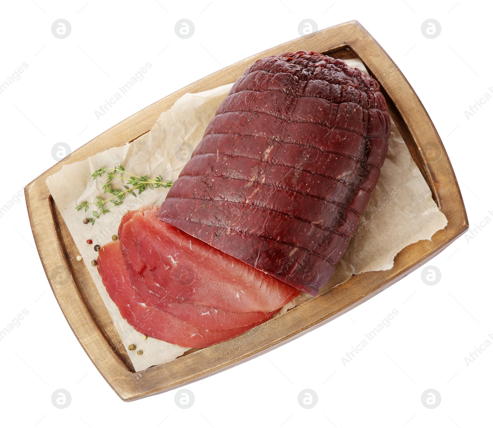 Photo of Tasty fresh dry bresaola, peppercorns and thyme isolated on white, top view