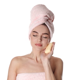 Young woman with soap bar on white background