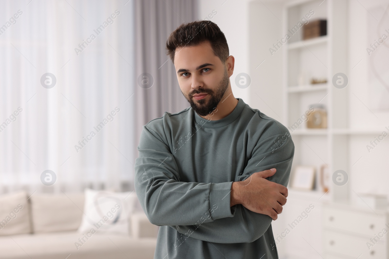 Photo of Handsome man in stylish sweater at home