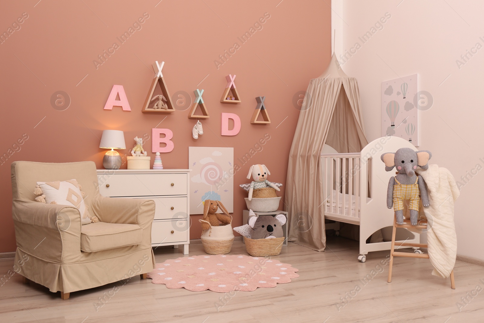 Photo of Baby room interior with stylish furniture and comfortable crib