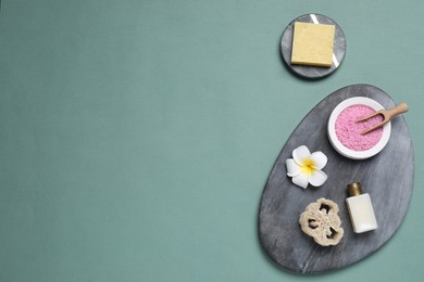 Flat lay composition with spa items on pale green background, space for text