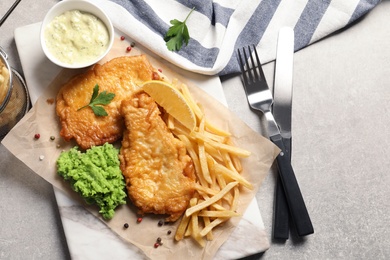 Photo of British traditional fish and potato chips on table, top view with space for text