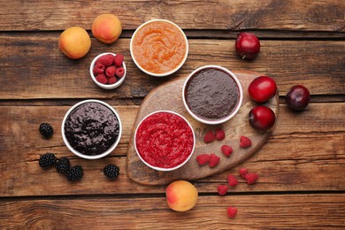 Photo of Different puree in bowls and fresh fruits on wooden table, flat lay