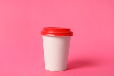 Photo of Takeaway paper coffee cup on pink background