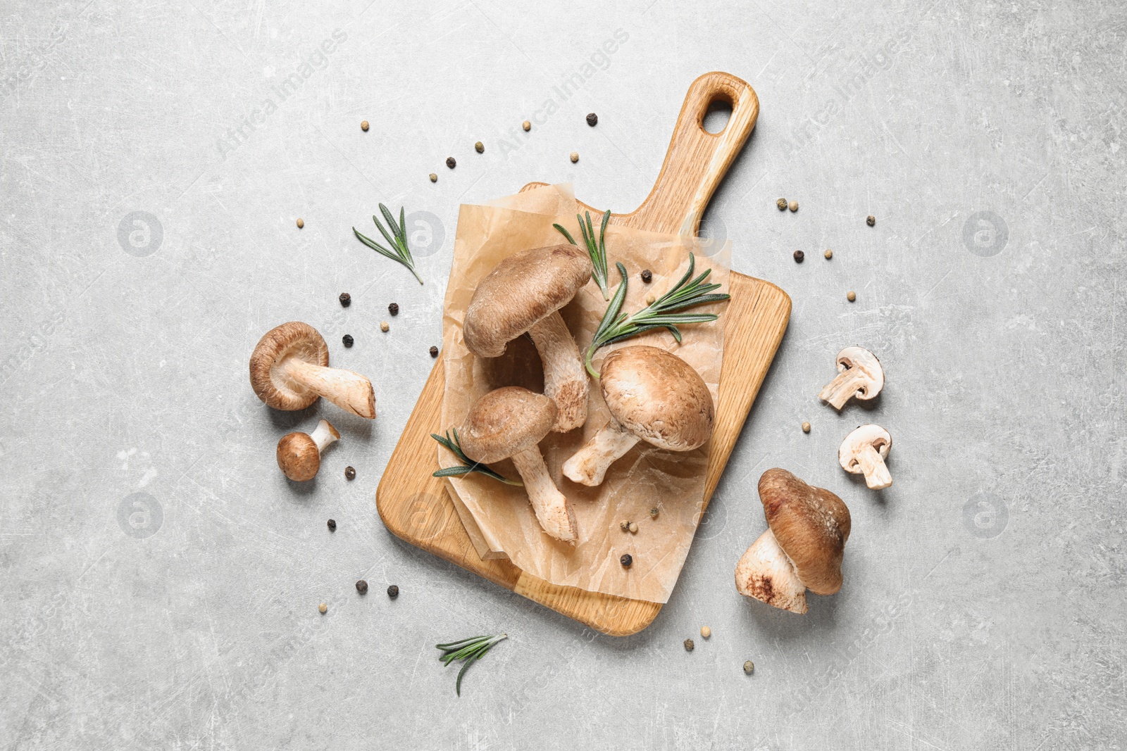 Photo of Flat lay composition with fresh wild mushrooms on light grey table