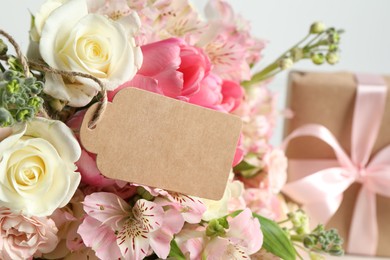 Photo of Happy Mother's Day. Beautiful flowers with blank card on light background, closeup