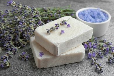 Photo of Hand made soap bars with lavender flowers on grey stone table