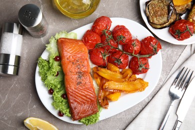 Photo of Tasty cooked salmon and vegetables served on grey table, flat lay. Healthy meals from air fryer