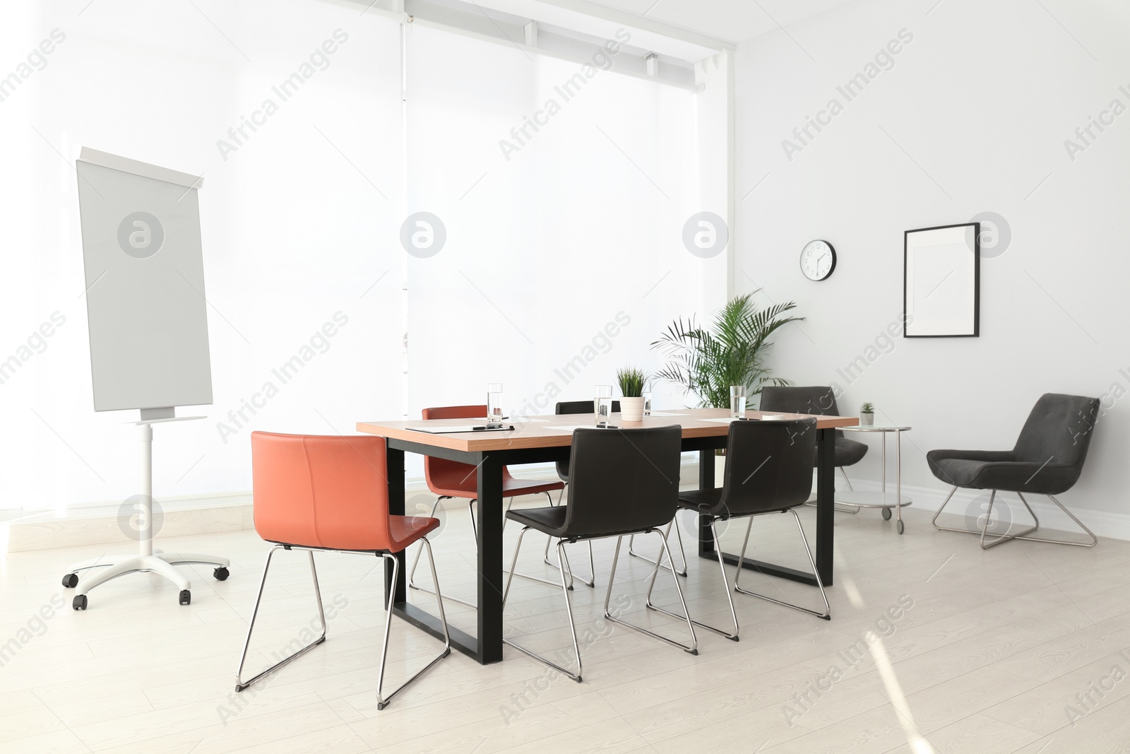 Photo of Simple office interior with large table and chairs