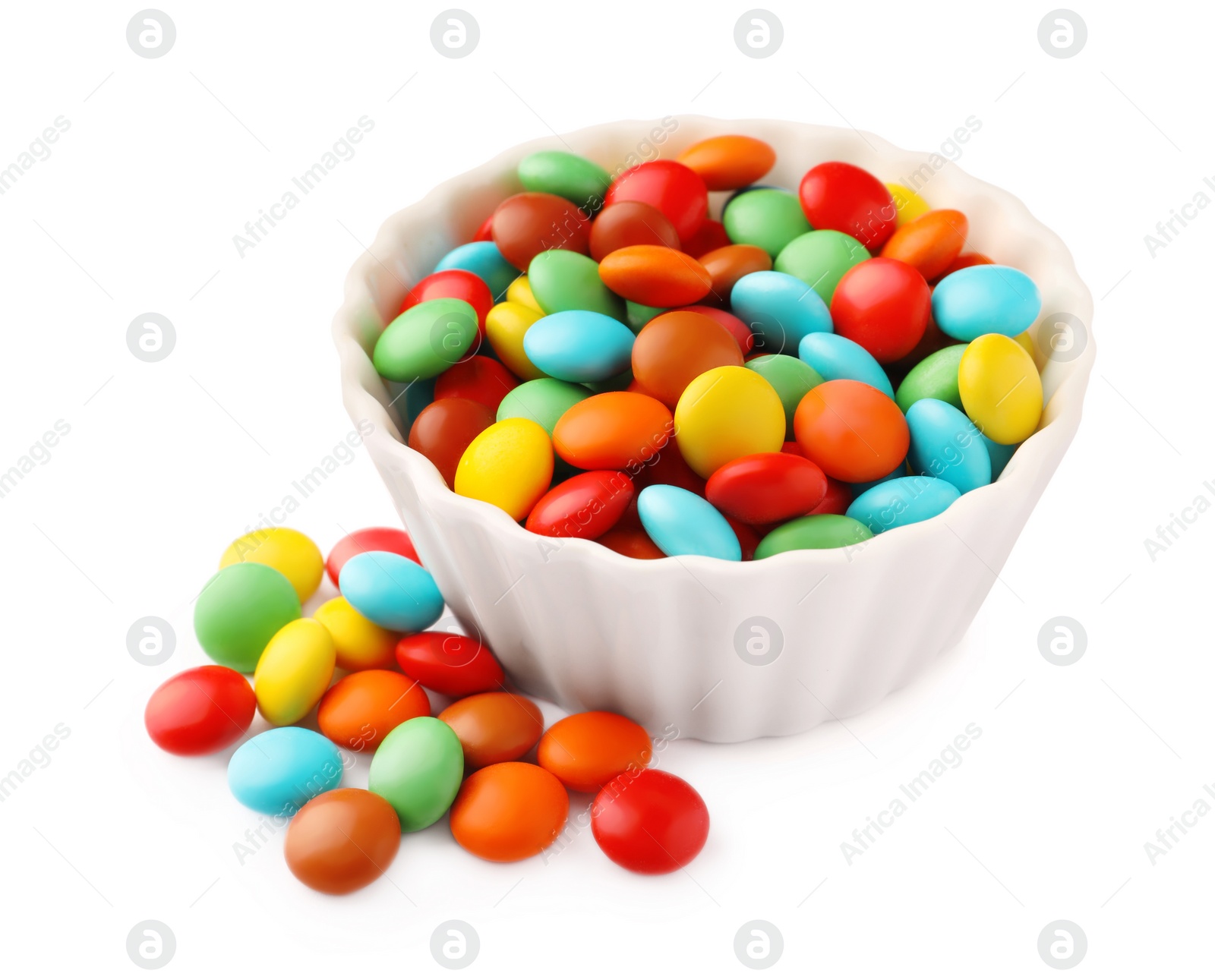 Photo of Bowl with colorful candies on white background