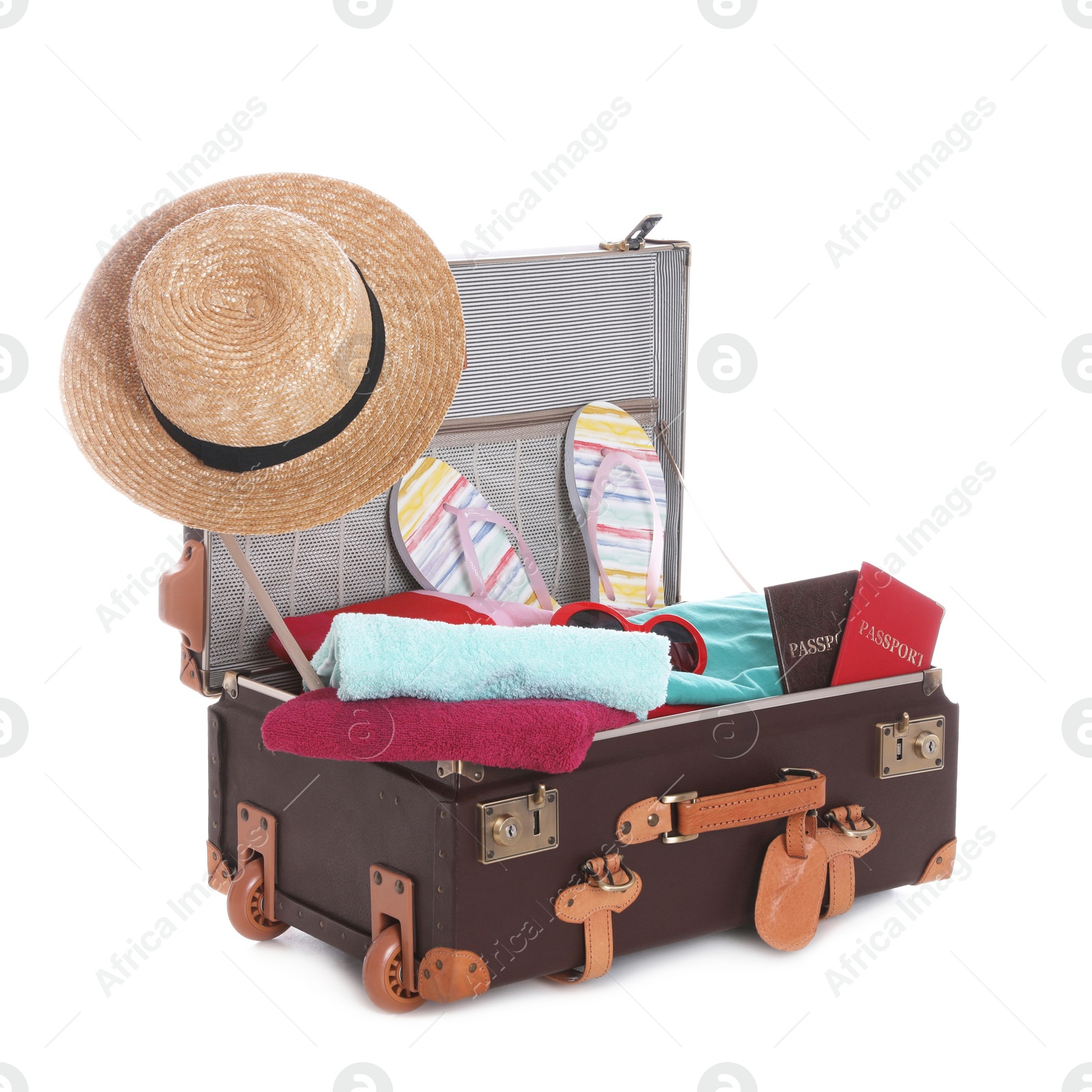 Photo of Open vintage suitcase with clothes packed for summer vacation isolated on white
