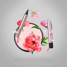 Image of Spring flowers and makeup products in air on grey background