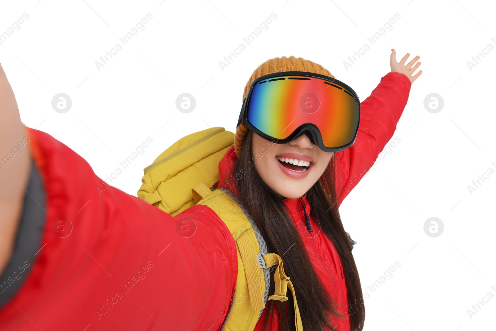 Photo of Smiling woman in ski goggles taking selfie on white background