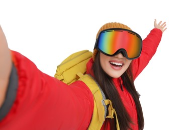 Photo of Smiling woman in ski goggles taking selfie on white background