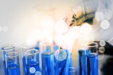 Image of Laboratory worker taking working test tube, closeup