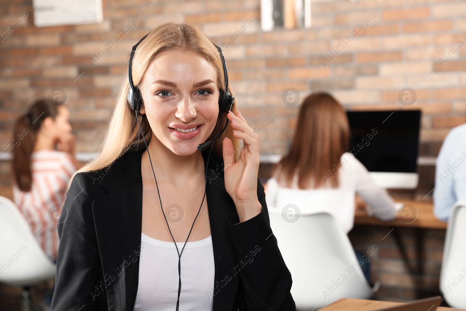 Photo of Technical support operator with headset in modern office