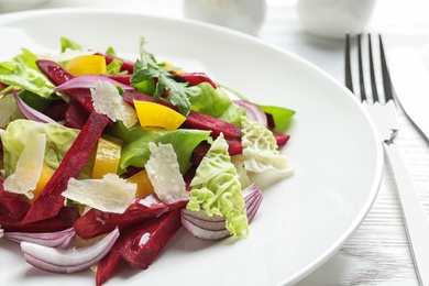 Plate with delicious beet salad on table, closeup