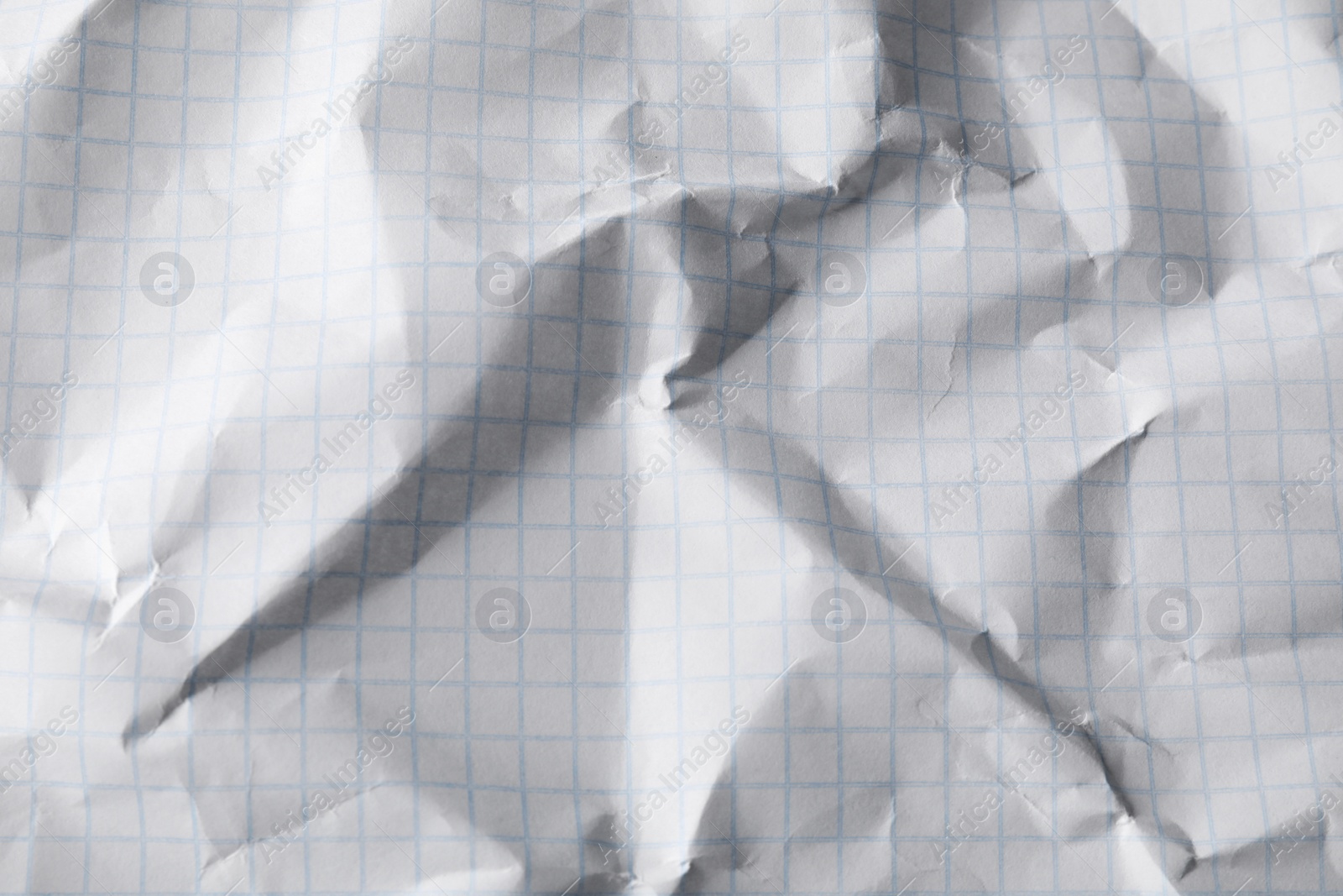 Photo of Crumpled sheet of paper as background, closeup