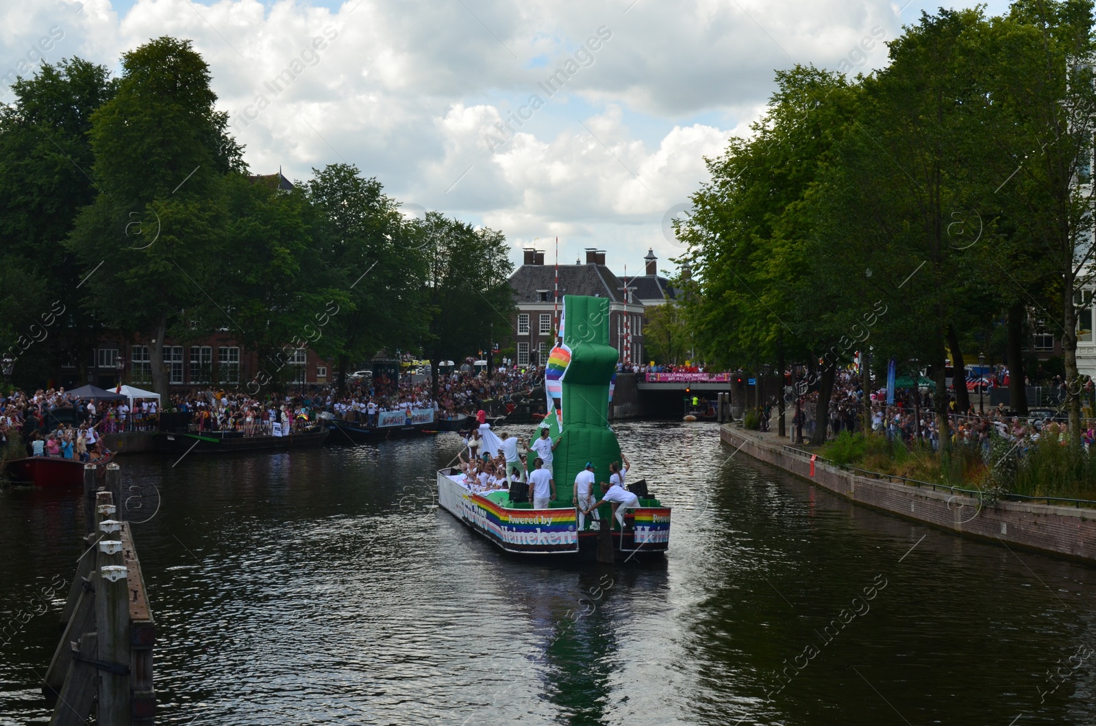 Photo of AMSTERDAM, NETHERLANDS - AUGUST 06, 2022: Many people in boats at LGBT pride parade on river