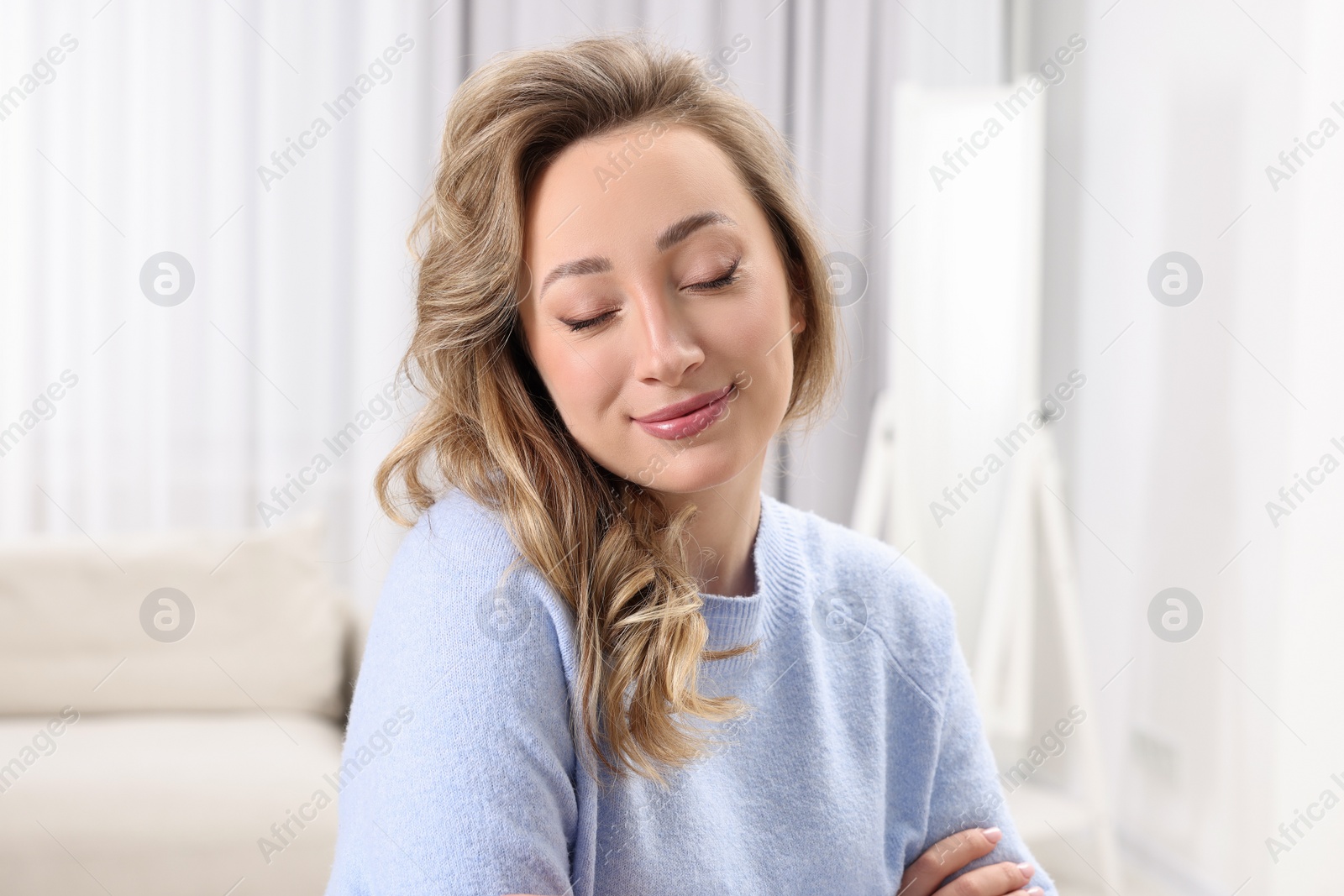 Photo of Portrait of beautiful woman with curly hair at home