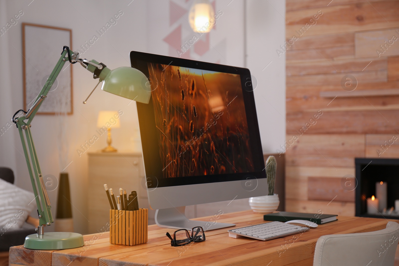 Photo of Comfortable workplace with modern computer on desk. Home office