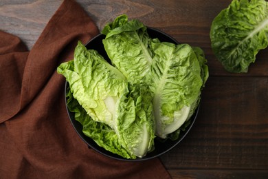Photo of Fresh green romaine lettuces on wooden table, flat lay