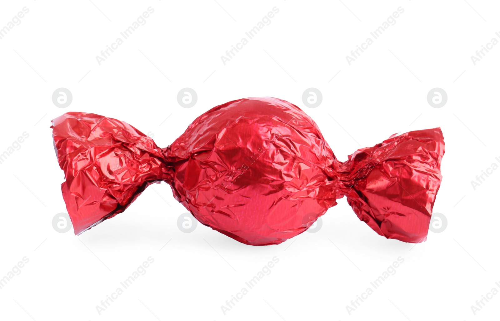 Photo of Tasty candy in red wrapper isolated on white