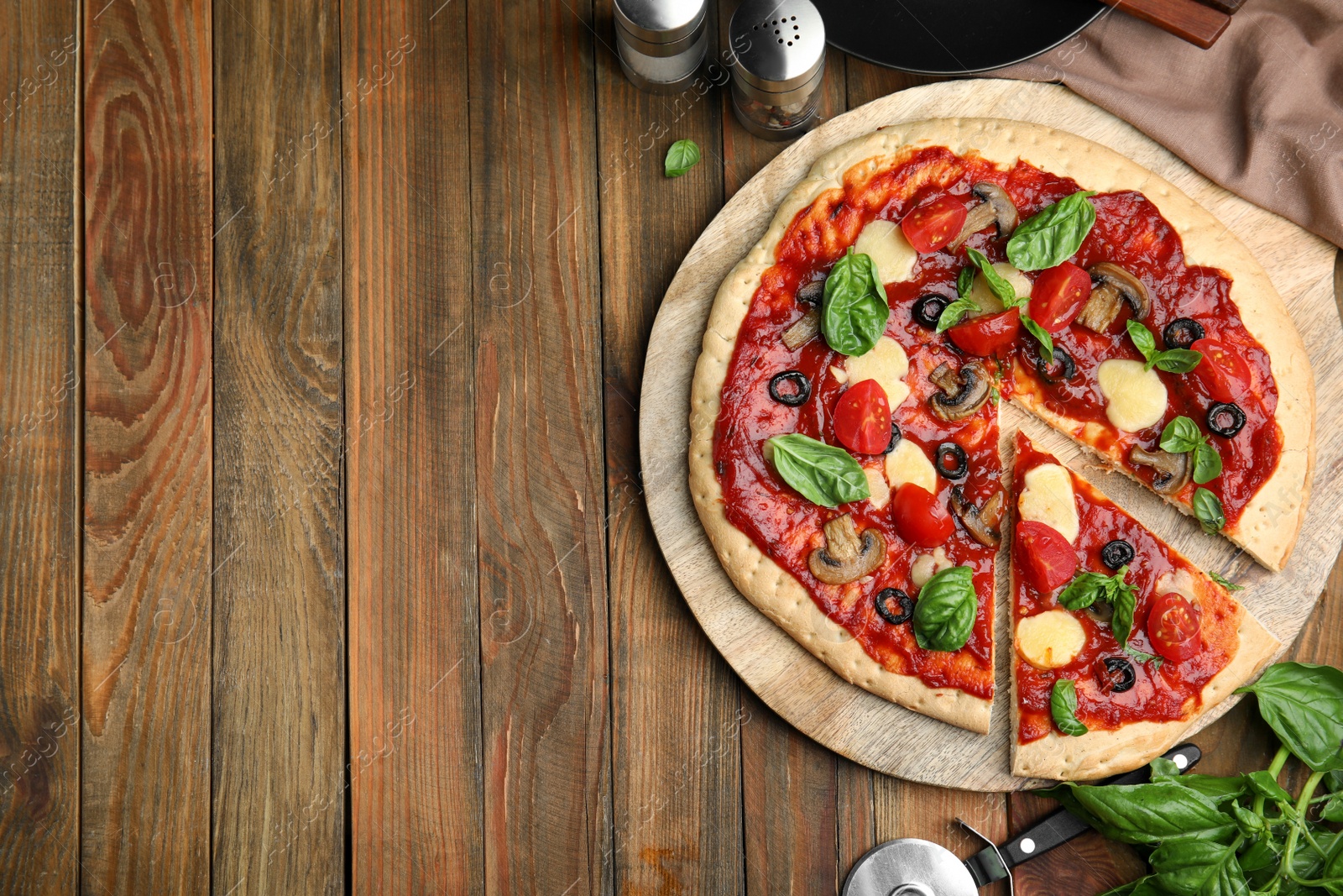 Photo of Delicious homemade pita pizza on wooden table, flat lay. Space for text