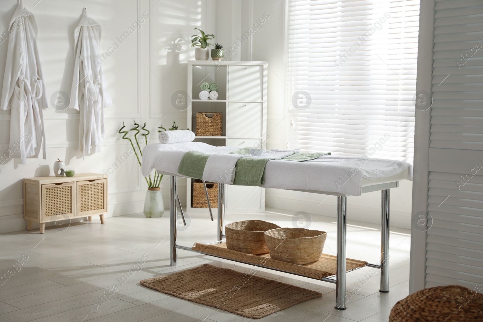 Photo of Stylish spa salon interior with massage table