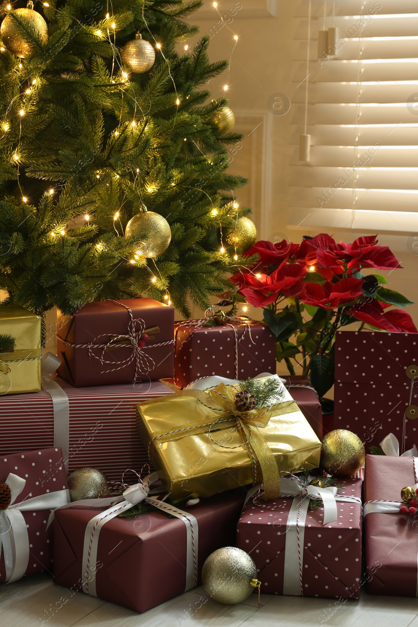 Photo of Many different gifts under Christmas tree indoors