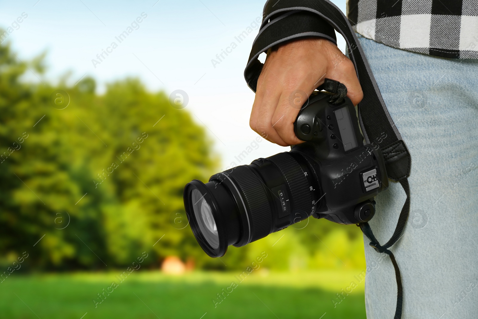 Image of Professional photographer with modern camera and blurred view of landscape, space for text