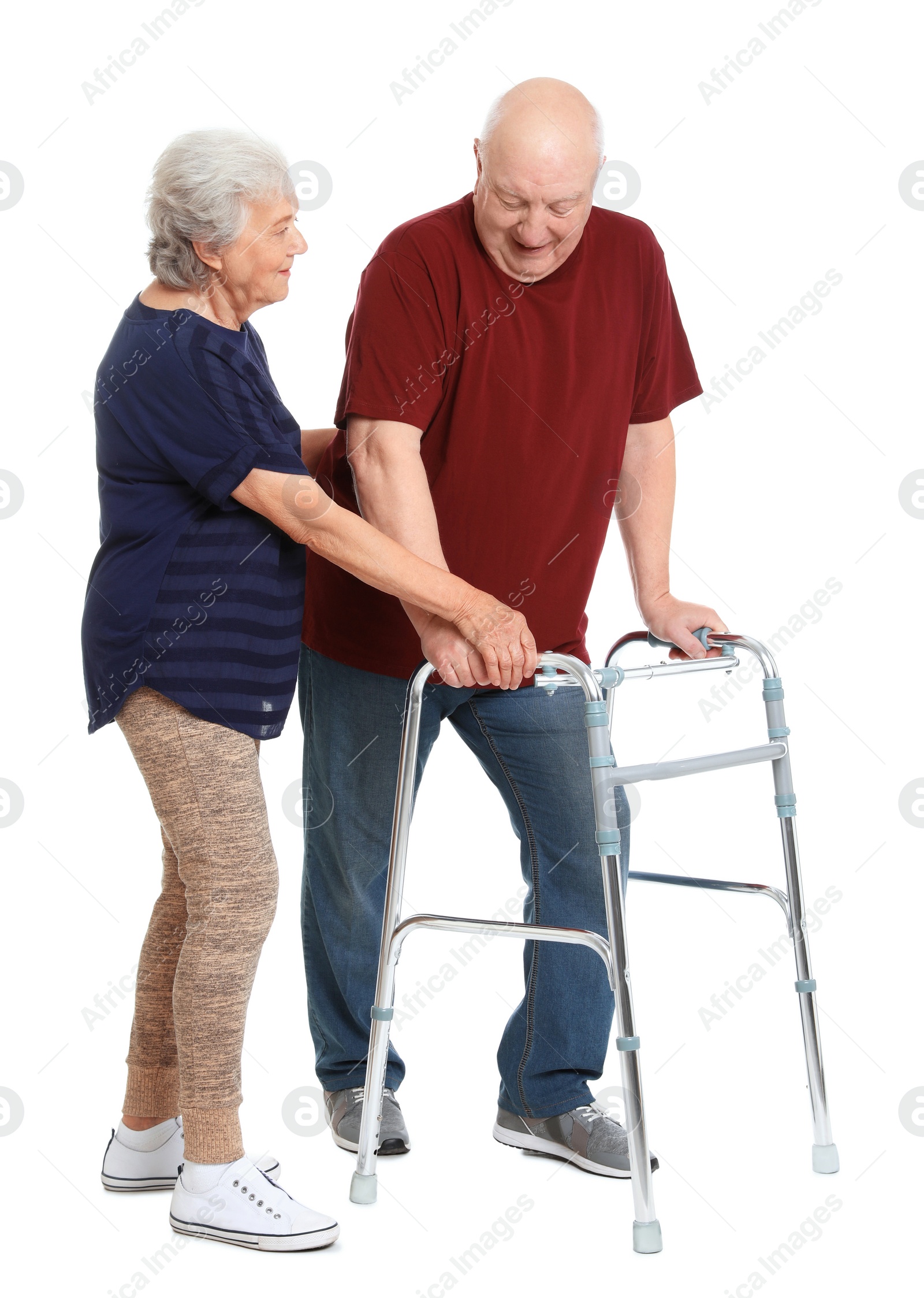 Photo of Elderly woman helping her husband with walking frame on white background