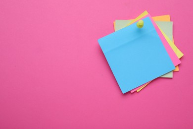 Photo of Colorful empty notes pinned on pink background, space for text