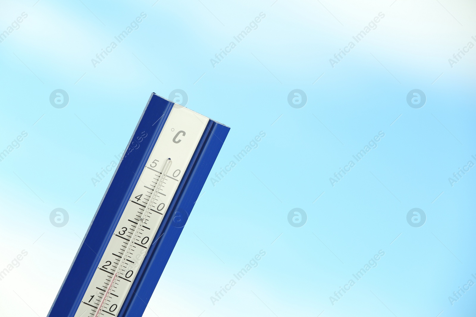 Photo of Weather thermometer and blue cloudy sky on background. Space for text