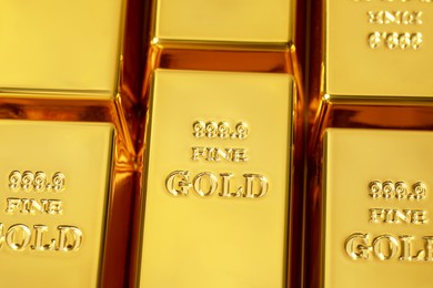Photo of Many shiny gold bars as background, above view