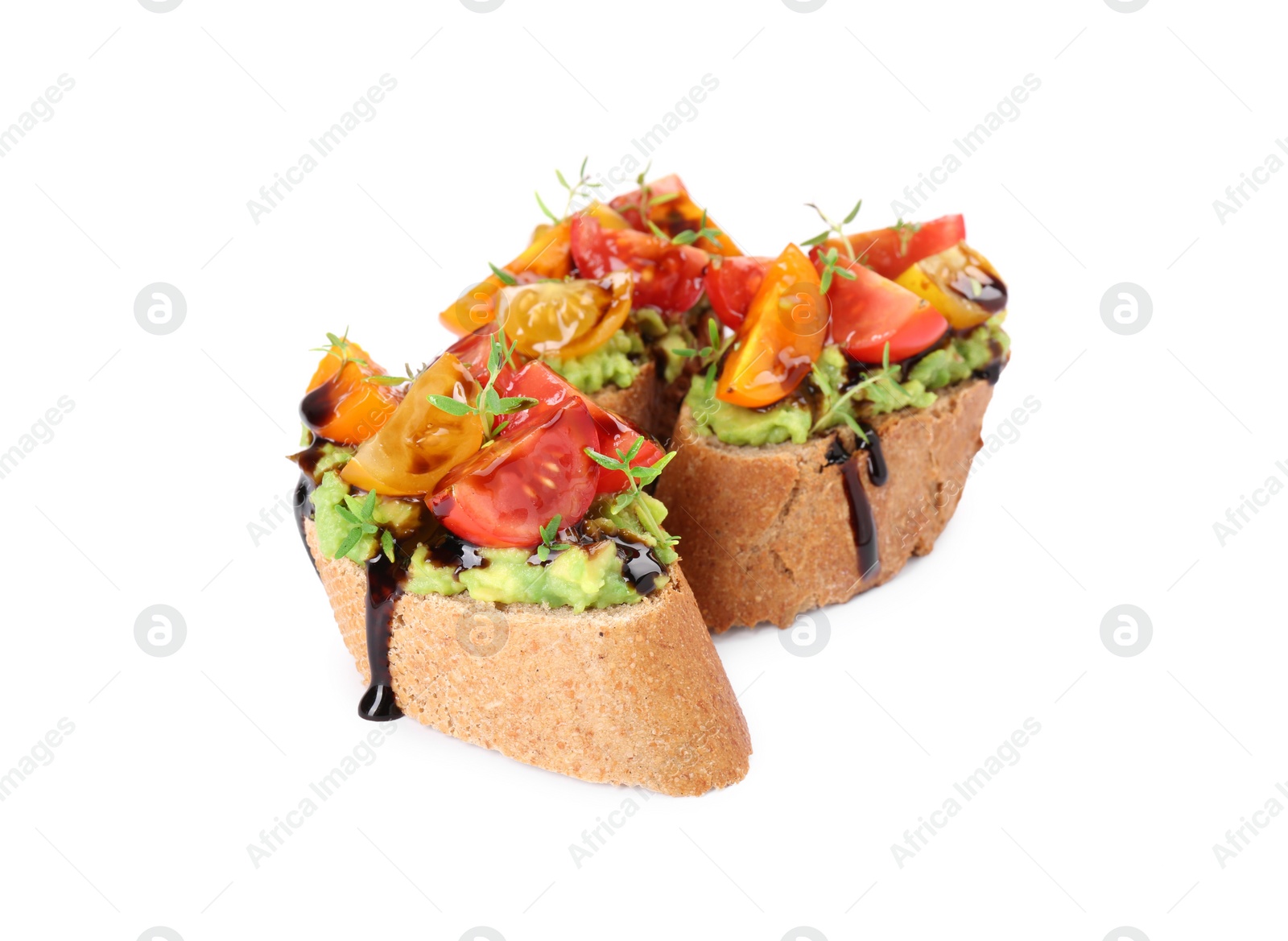 Photo of Delicious bruschettas with avocado, tomatoes and balsamic vinegar isolated on white