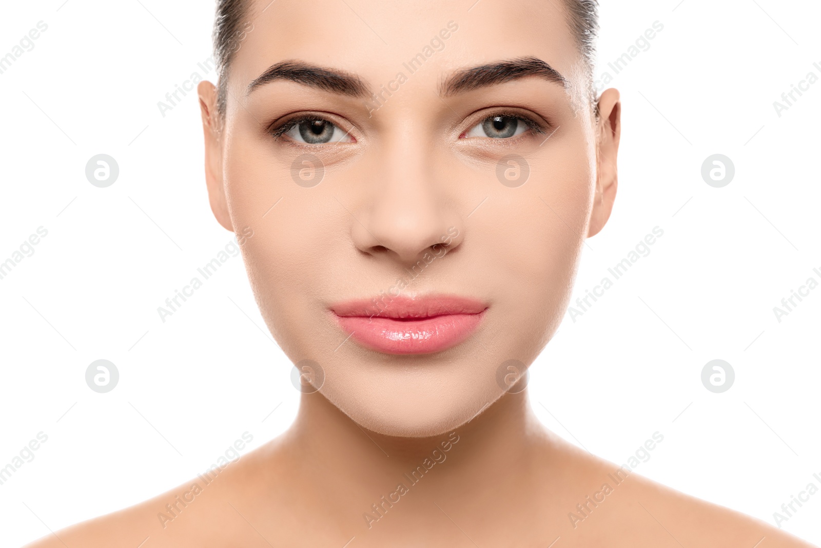 Photo of Portrait of young woman with beautiful face and natural makeup on white background, closeup