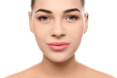 Photo of Portrait of young woman with beautiful face and natural makeup on white background, closeup