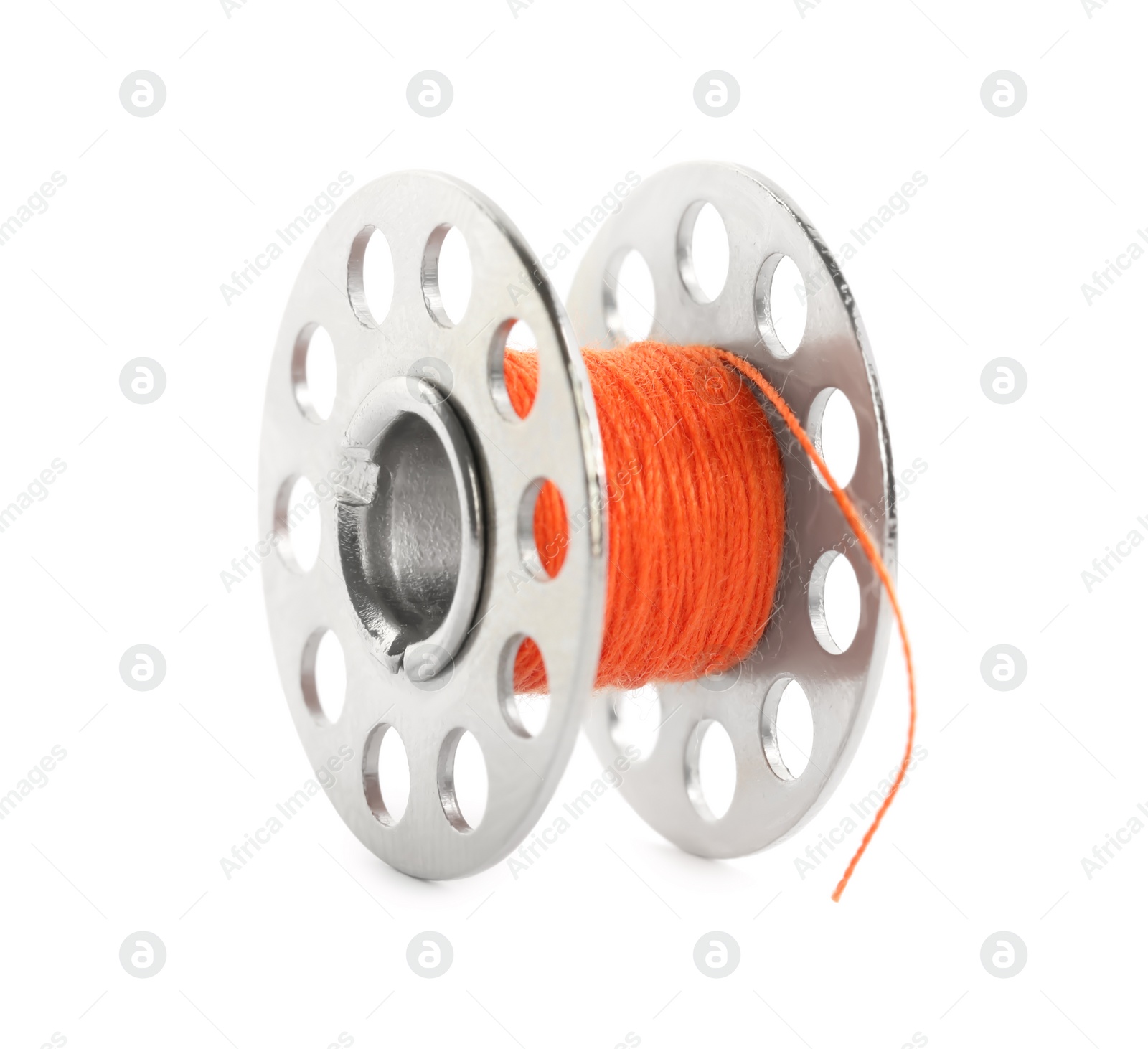 Photo of Metal spool of orange sewing thread isolated on white