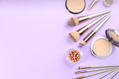 Photo of Flat lay composition with makeup brushes on violet background, space for text