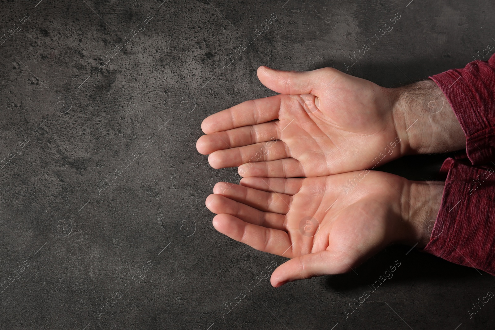 Photo of Man showing palms at table, top view with space for text. Chiromancy and foretelling