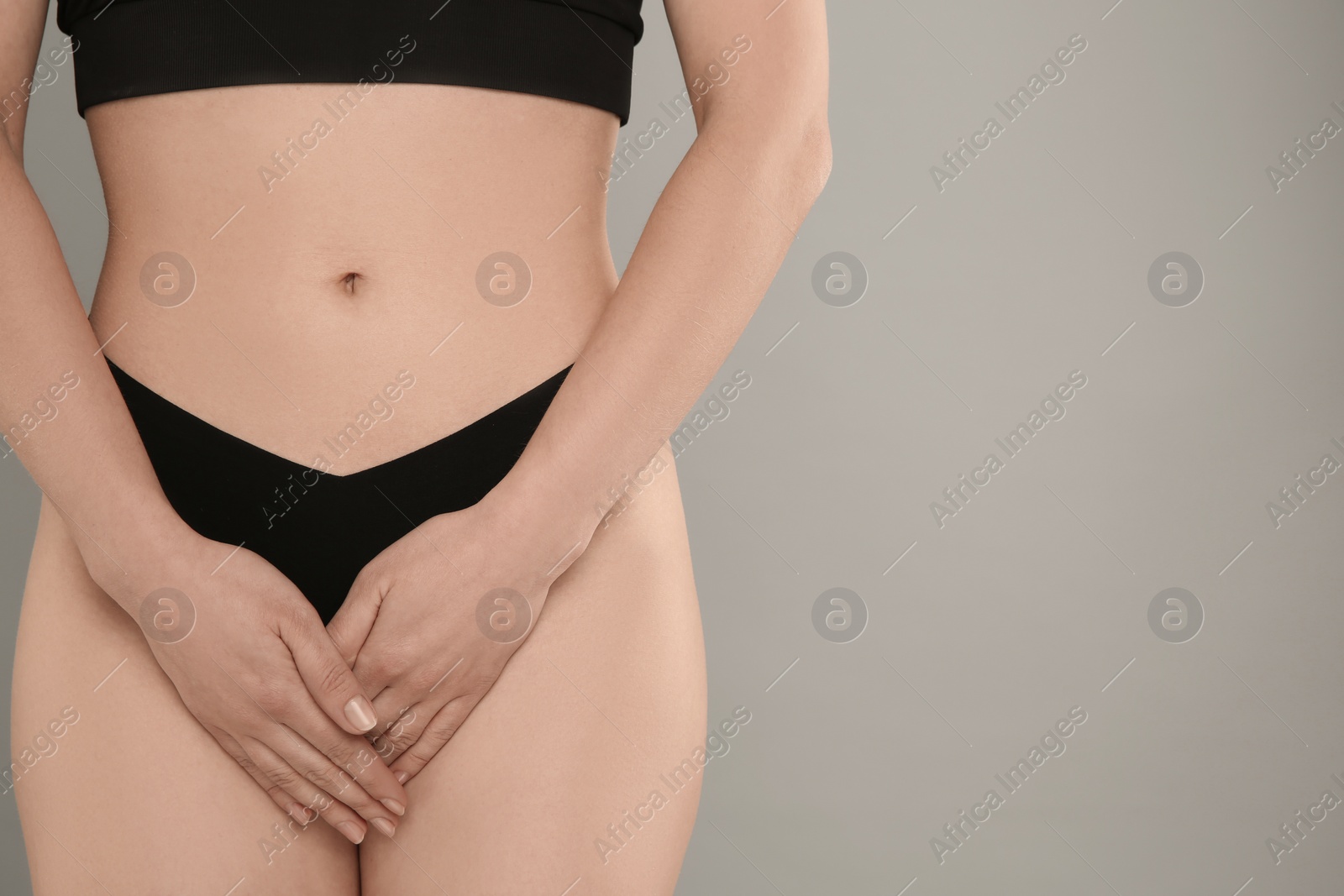 Photo of Gynecology. Woman in underwear on grey background, closeup. Space for text