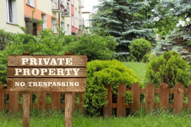 Image of Wooden sign with text Private Property No Trespassing near house