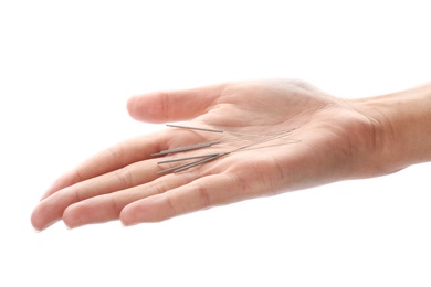 Photo of Woman holding needles for acupuncture on white background