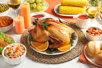 Photo of Delicious roasted turkey with garnish on dinner table