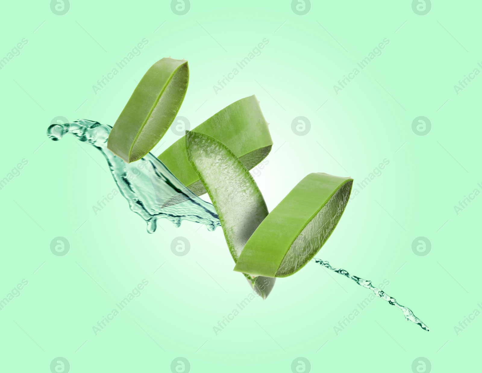 Image of Sliced aloe vera leaf and splash of juice on aquamarine background