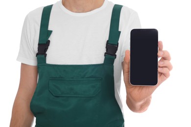 Photo of Professional repairman in uniform with phone on white background, closeup