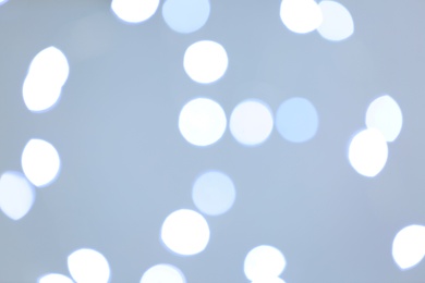 Photo of Beautiful blurred lights on bright background, bokeh effect